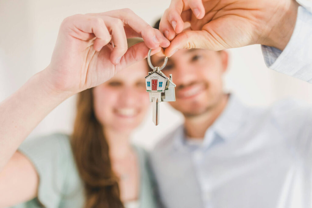 First home buyers holding keys to new home